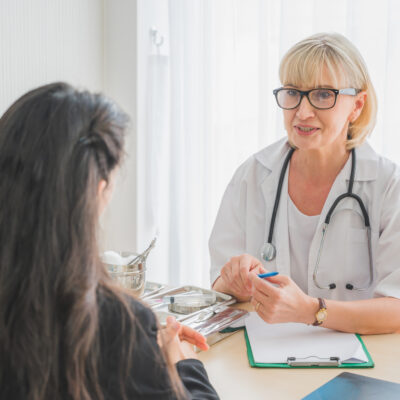 Senior female doctor meet the patient discussing and making note