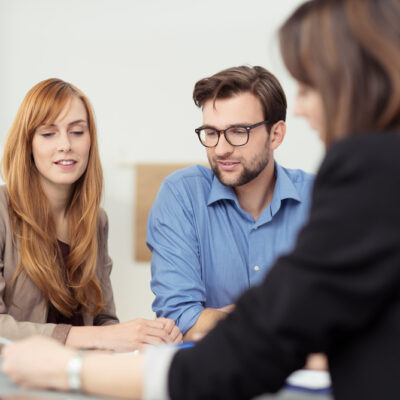 Broker making a presentation to a young couple