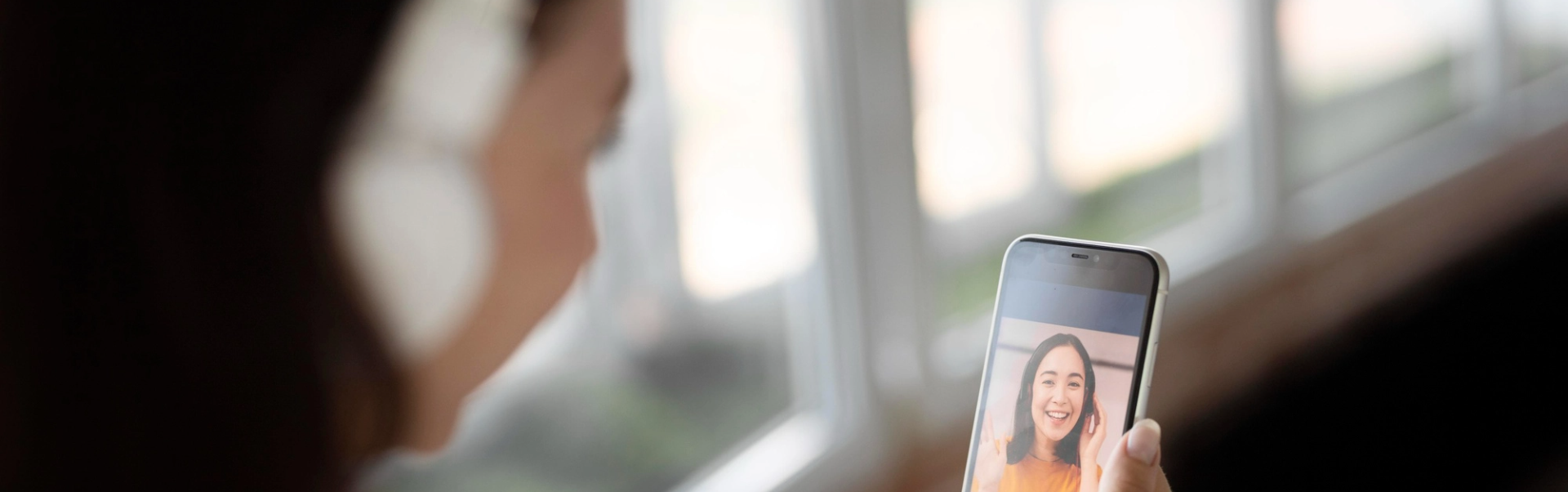 Blurry photo of a woman on a video call.
