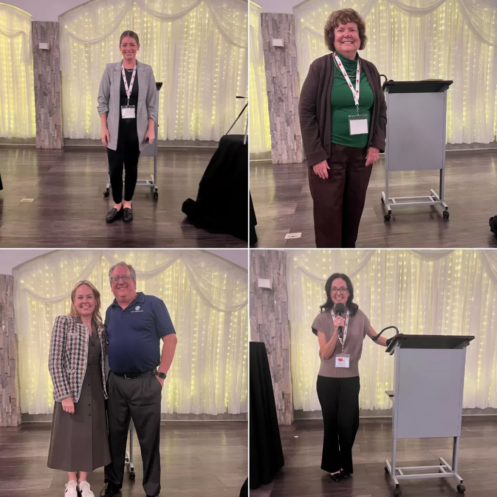 Photograph of 5 speakers at conference